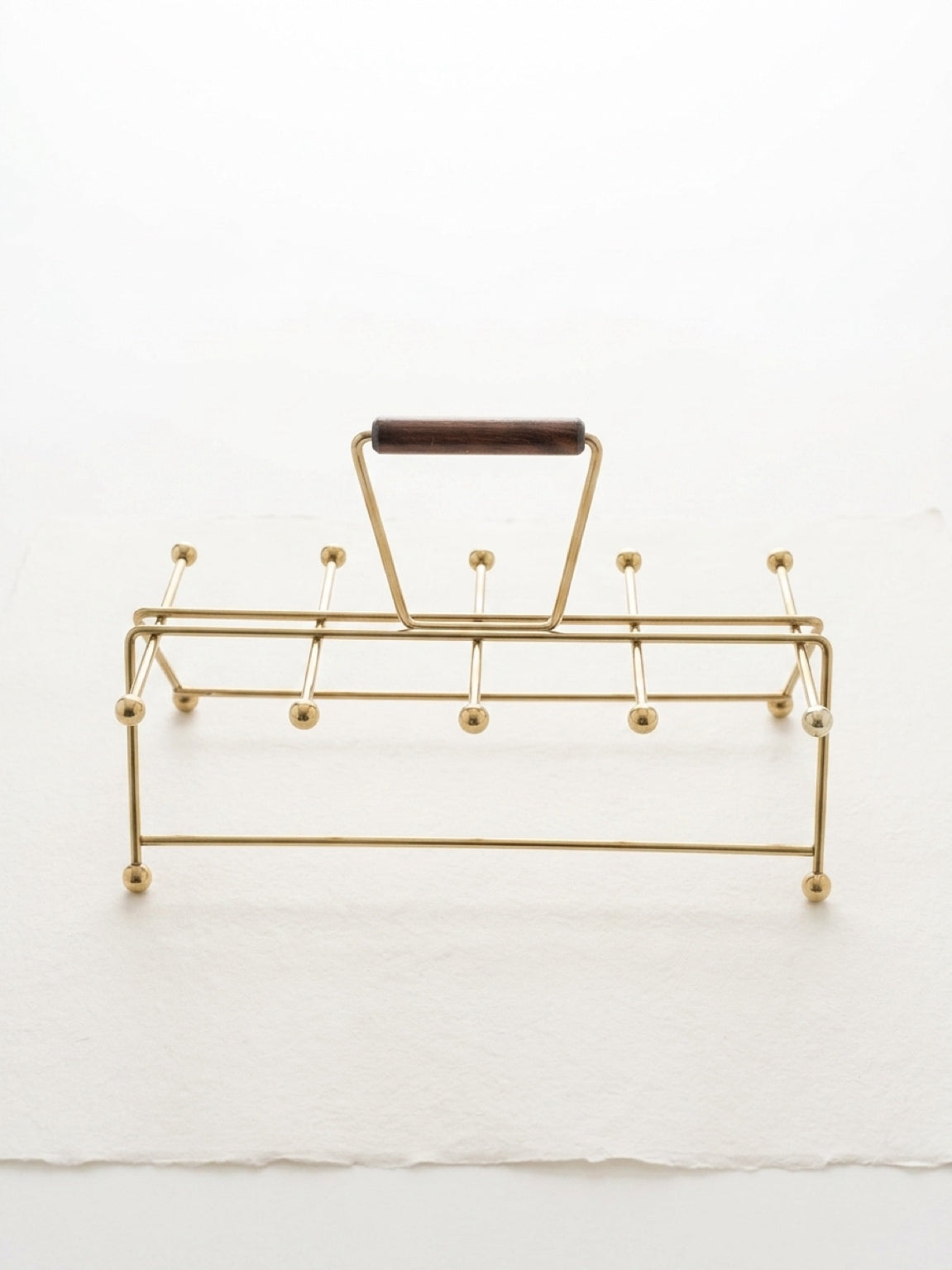 Gold vintage mid century modern atomic age drink carrier with a wooden handle on a white background