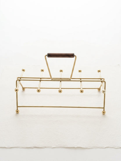 Gold vintage mid century modern atomic age drink carrier with a wooden handle on a white background