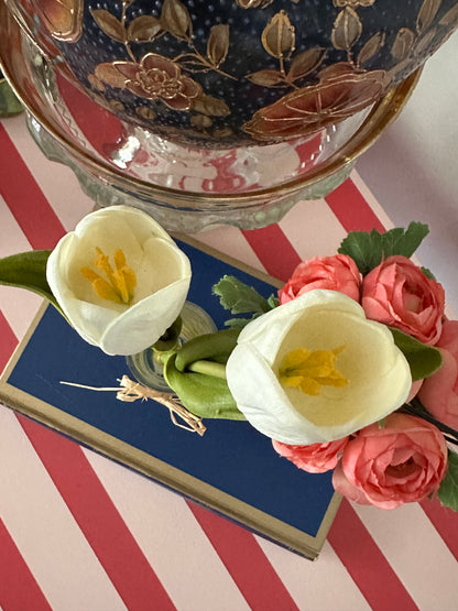 Framed picture of flowers on a table with decorative elements