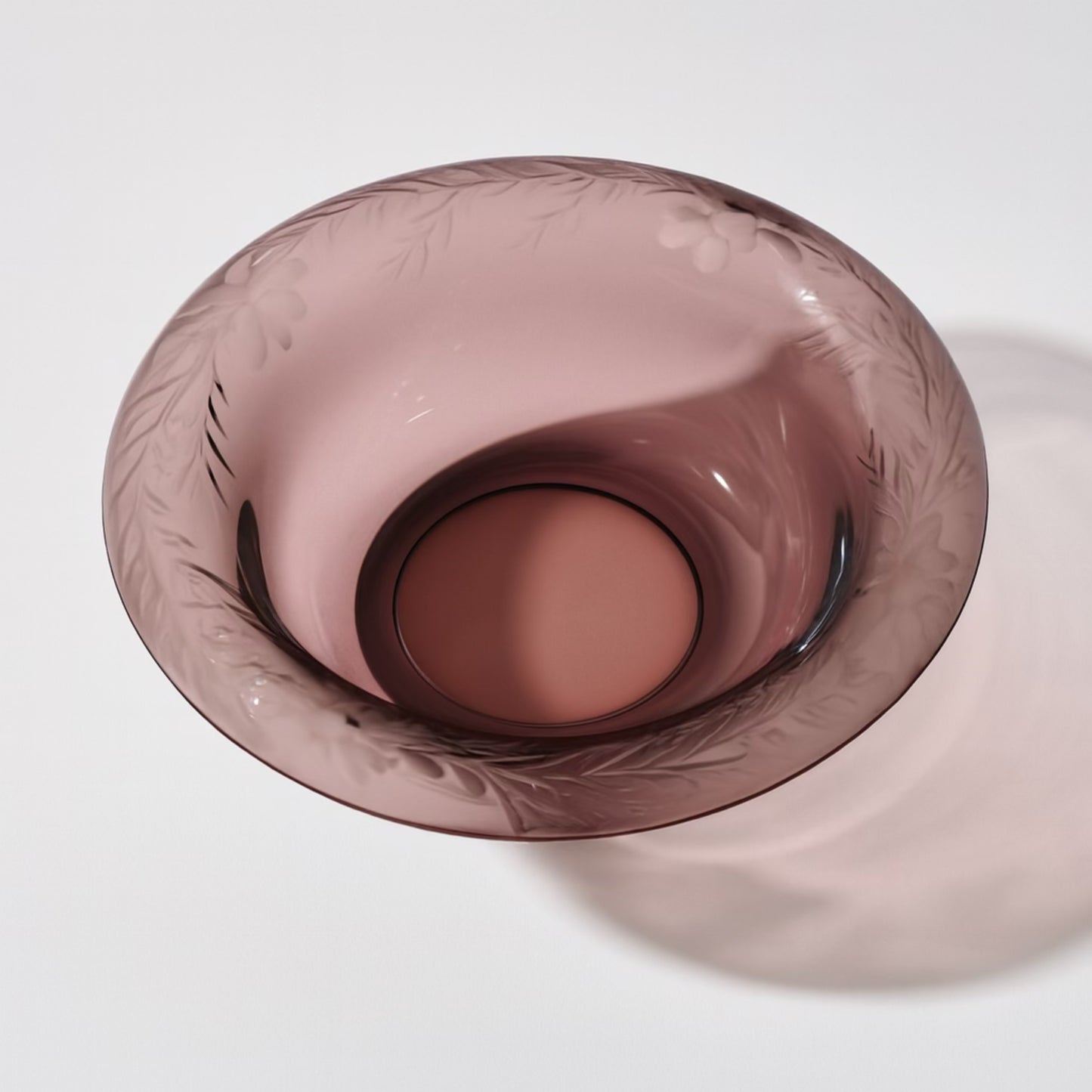 Elegant etched pink glass bowl with floral design, perfect for decor or serving.