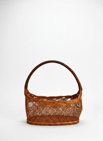 Front view of a vintage mid-century Japanese bamboo Hanakago flower basket featuring a boat-shaped silhouette and a dramatic high-arching bentwood handle against a crisp white background.

