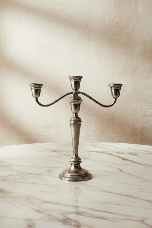 Gorham Newport silverplate 3-light candelabra with warm oxidized patina, styled on a marble surface against a neutral linen backdrop