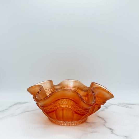 Vintage orange glass bowl, wavy design, decorative piece for home decor or tabletop display.