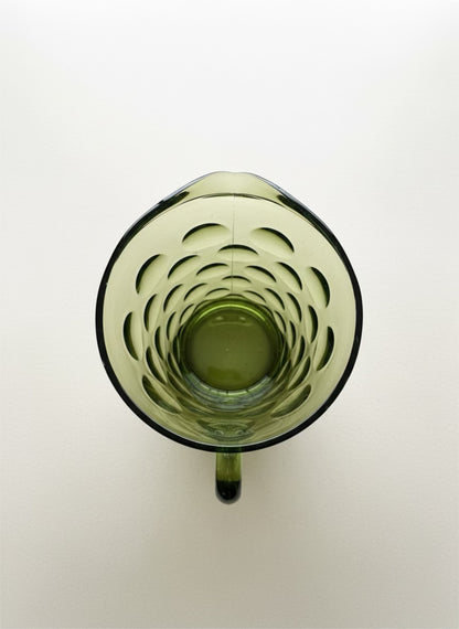 Green glass mug with a unique interior design on a white background