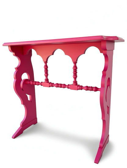 Pink decorative table with intricate design on a white background