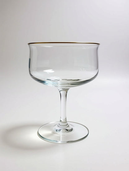 Clear glass with gold rim on a white background Image of single Lennox mid-century, modern coupe glass that belongs to a set of four in a vintage collection