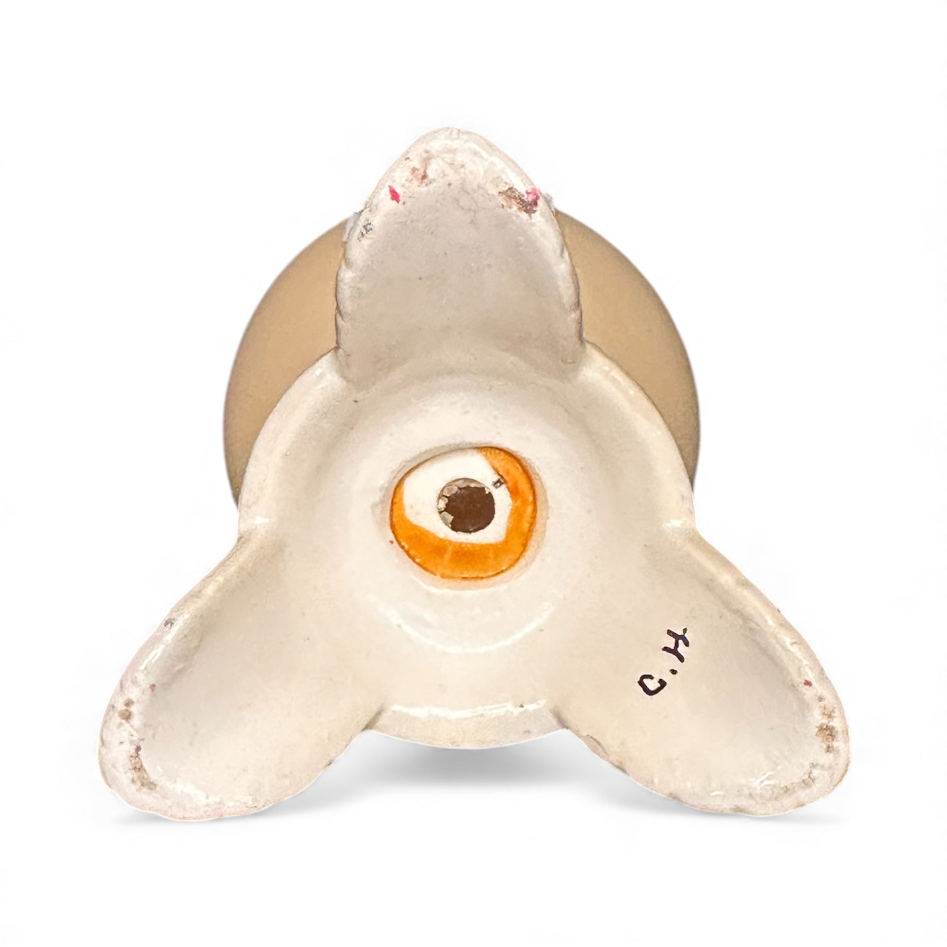 Decorative ceramic piece resembling a shark with a gold base on a white background