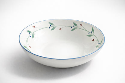 Dansk Portugal XL pasta bowl with botanical rim pattern of green leaves, blue berries, and red buds, photographed on white background for catalog or resale