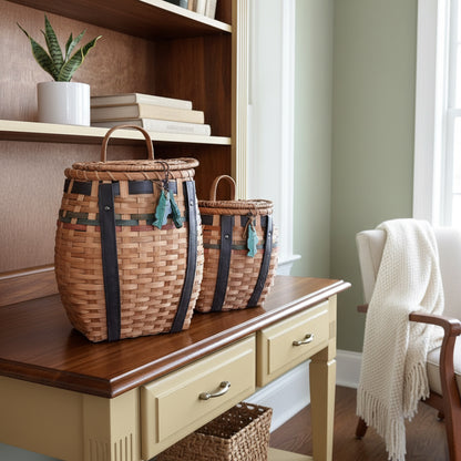 Set of two woven wicker storage baskets with leather accents, natural color, perfect for home organization.