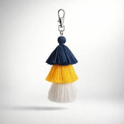 Colorful navy blue white yellow tassel keychain with a silver clasp on a white background