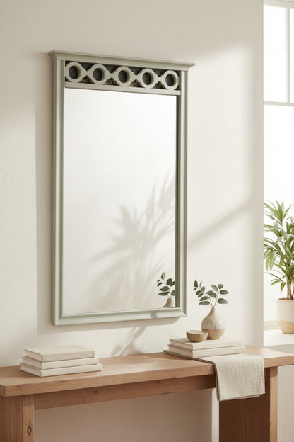 Elegant rectangular mirror with a light green frame and decorative circular top, perfect for modern decor.