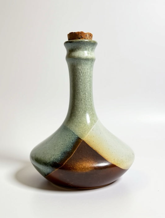 Mid-century modern stoneware bottle by Pottery Craft with original oversized cork stopper, styled as an artisanal water carafe or decorative ceramic sculpture.