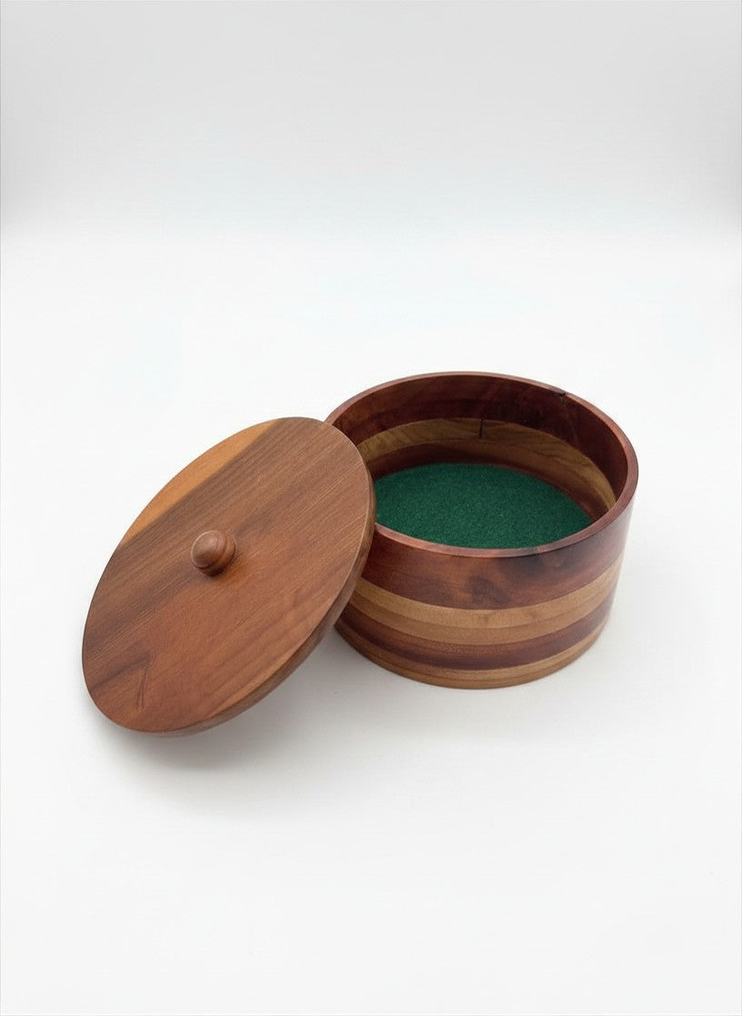 Open vintage round wooden box showing the vibrant forest green felt-lined interior and the turned wood lid resting beside it.