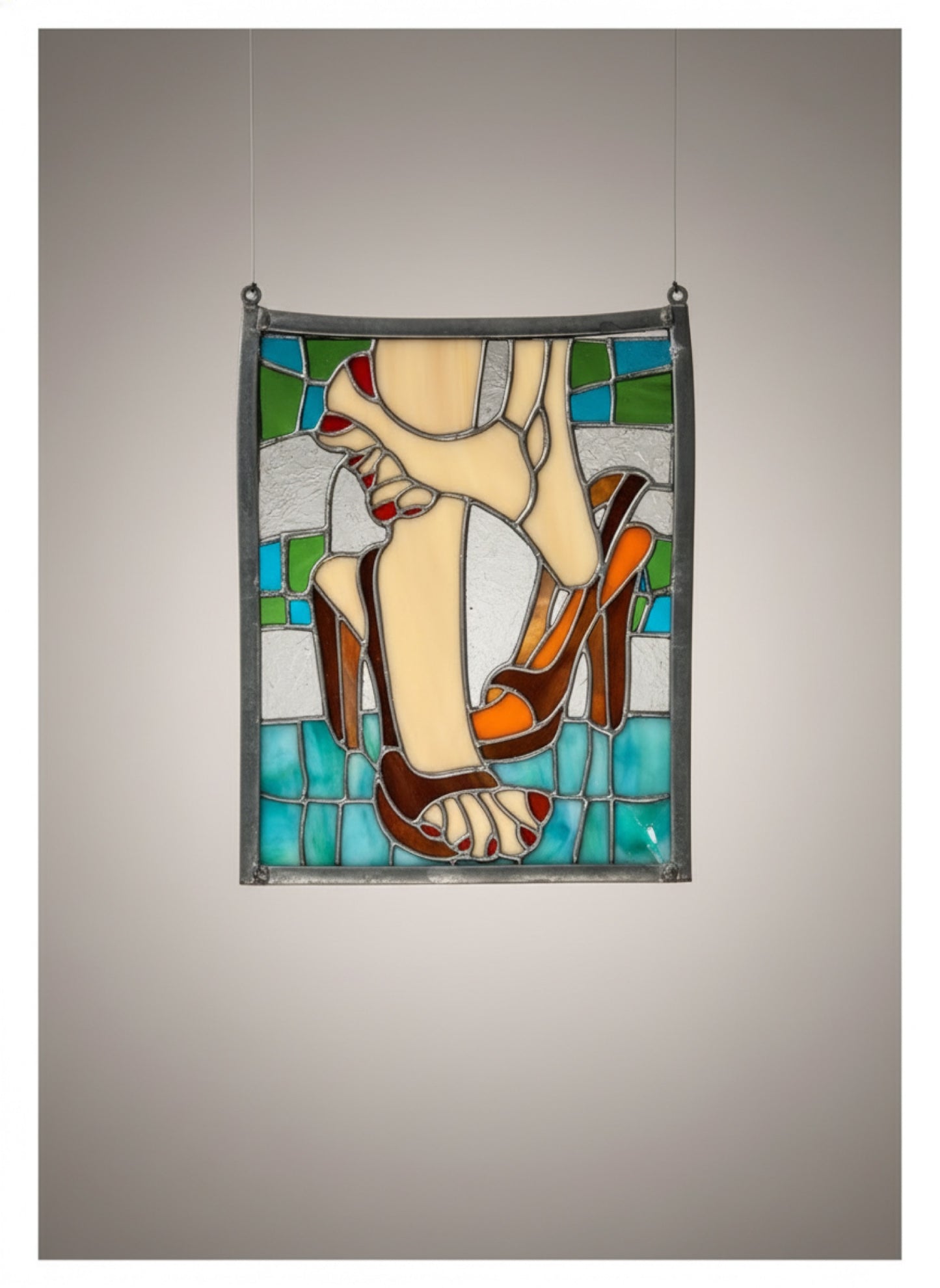 Vintage stained glass decor of feet and high heels featuring blue, white, beige, tan