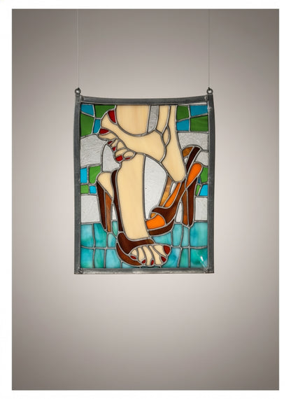 Vintage stained glass decor of feet and high heels featuring blue, white, beige, tan