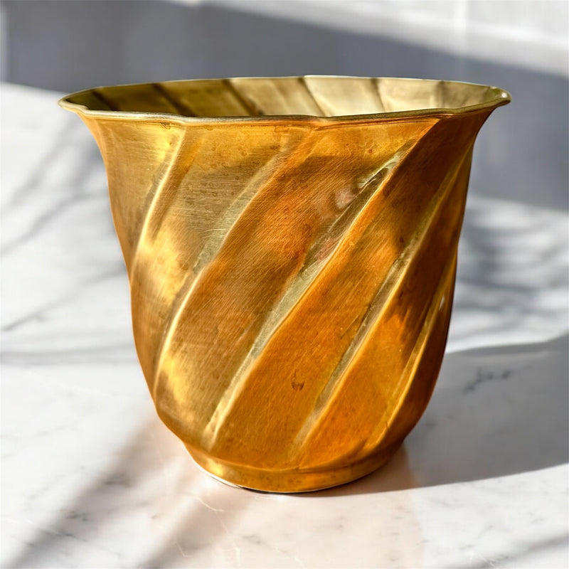 Gold brass vase with twisted design, perfect for modern home decor.