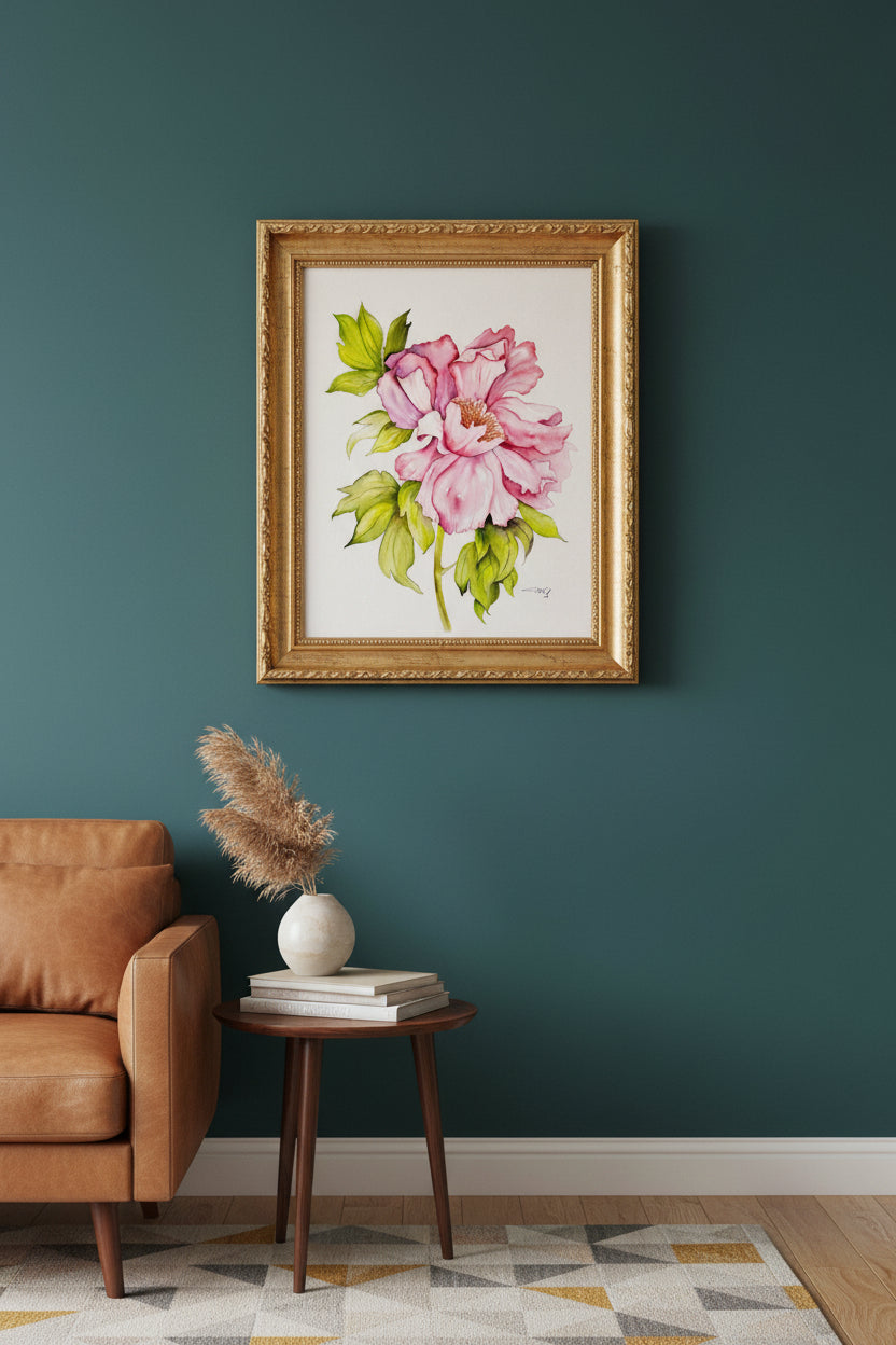 Floral painting of a pink flower with green leaves on a white background in a gold frame in a mid century modern home with dark teal walls