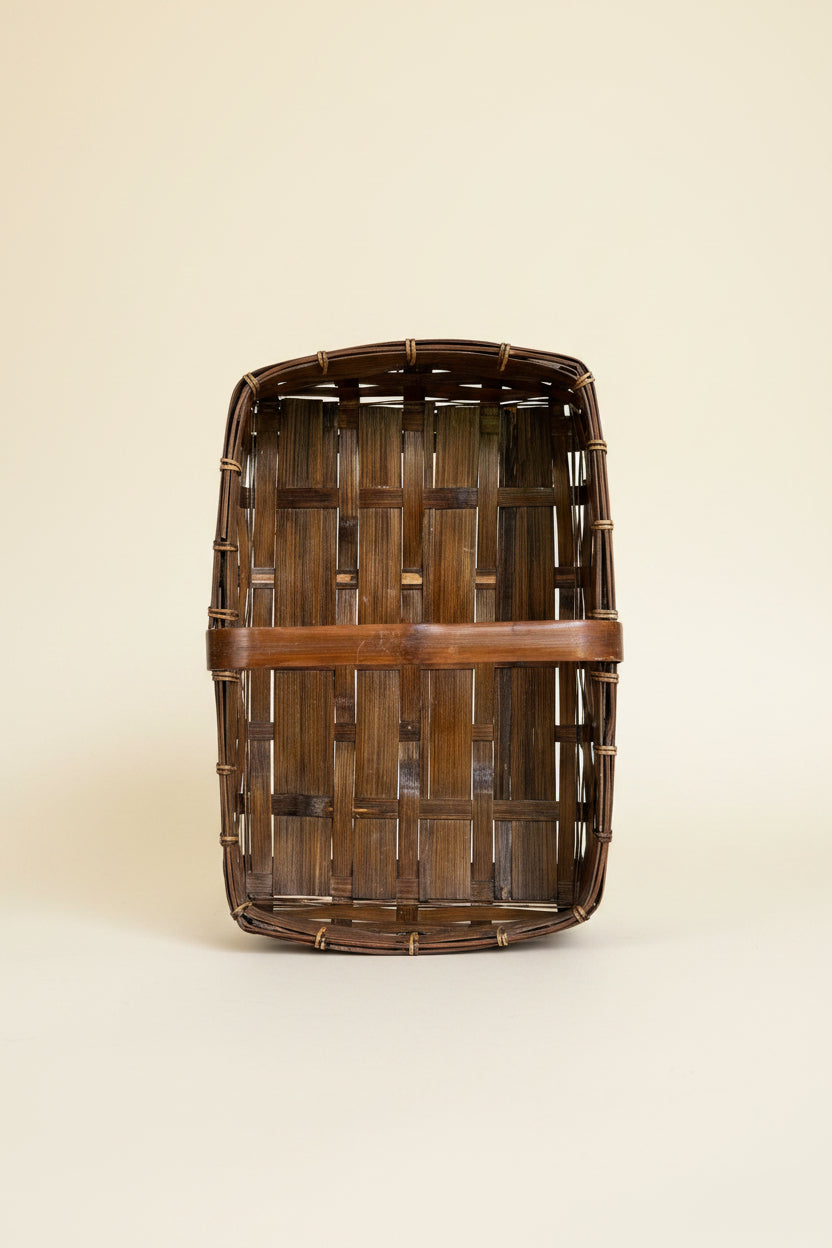 Top-down interior view of a vintage rectangular split bamboo trug basket showing the woven flat bottom wood structure and cane-wrapped rim construction.