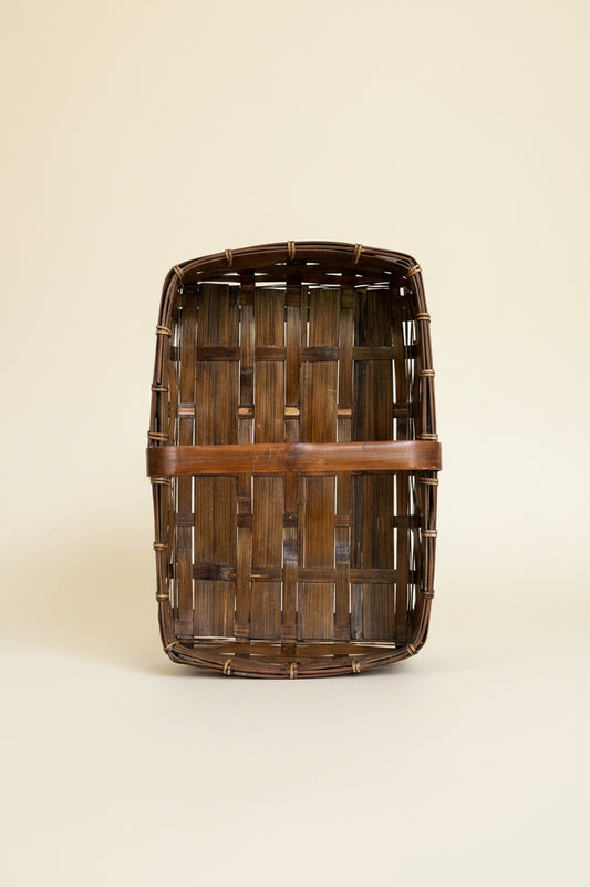 Top-down interior view of a vintage rectangular split bamboo trug basket showing the woven flat bottom wood structure and cane-wrapped rim construction.
