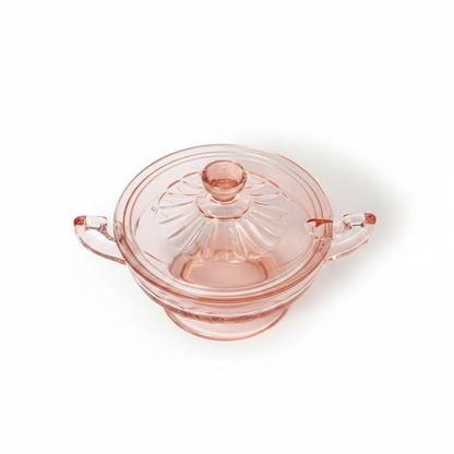 Top-down perspective looking at the lidded pink depression glass sugar bowl, focusing on the decorative faceted finial and the fluted pattern on the lid, set against a white background.