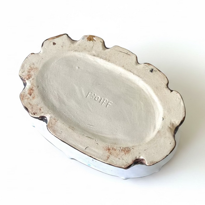 Unglazed earthenware bottom of a vintage ceramic planter showing the impressed mold serial number P301PF.⁠