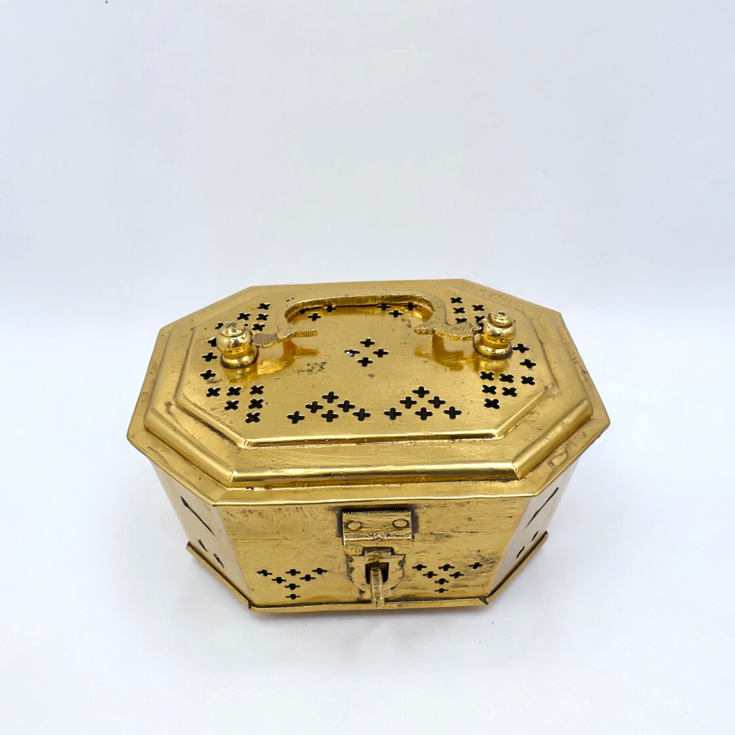 Gold octagonal jewelry box with intricate designs on a white background