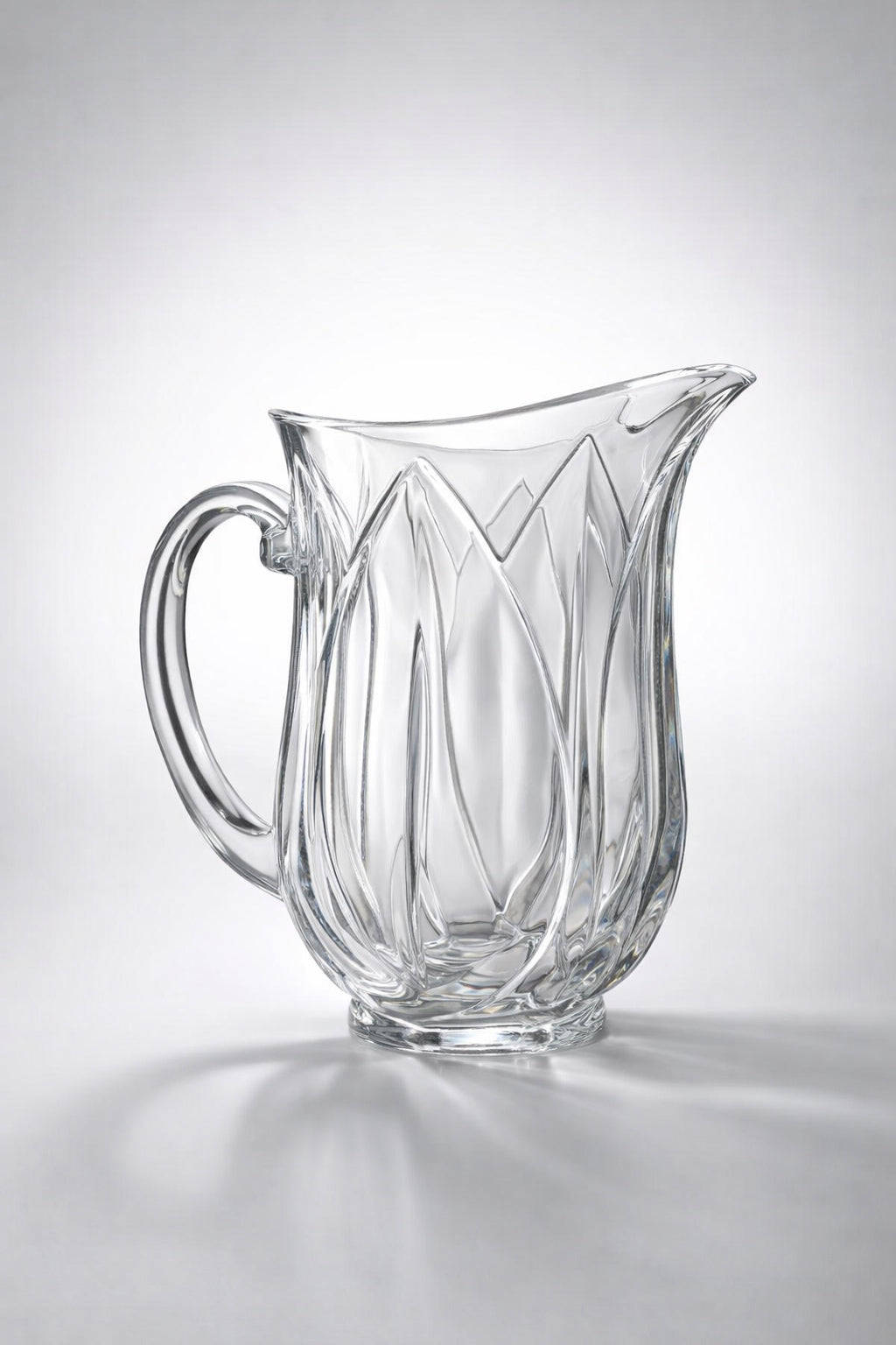 Clear glass pitcher with decorative design on a gray background - Vintage Cristal d'Arques "Pompano" Glass Pitcher | Pressed Glass Tulip Pattern | Made in France