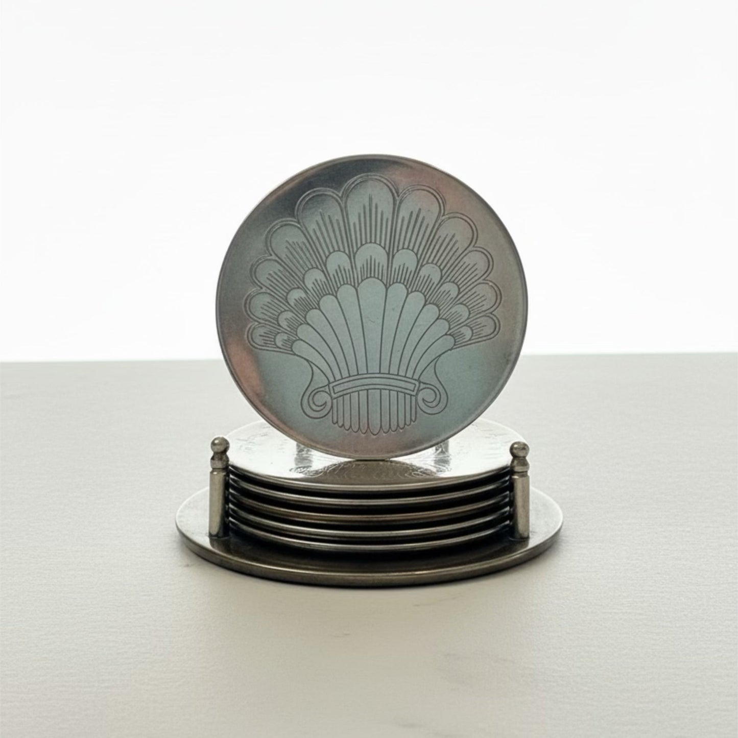 Vintage Silver-Plated Scallop Shell Coasters & Ball-Foot Caddy – Set of 6Set of coasters with a decorative design on a white surface