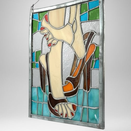Vintage stained glass decor of feet and high heels featuring blue, white, beige, tan
