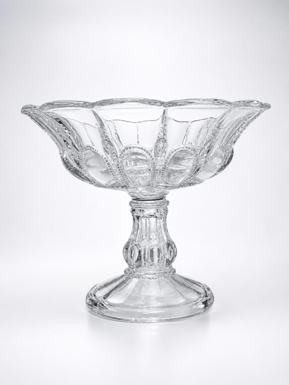 Studio profile shot of a vintage Early American Pattern Glass (EAPG) clear pedestal compote bowl in the "Beautiful Lady" pattern by Bryce Higbee, featuring a detailed multi-sided pedestal base and flared rim.