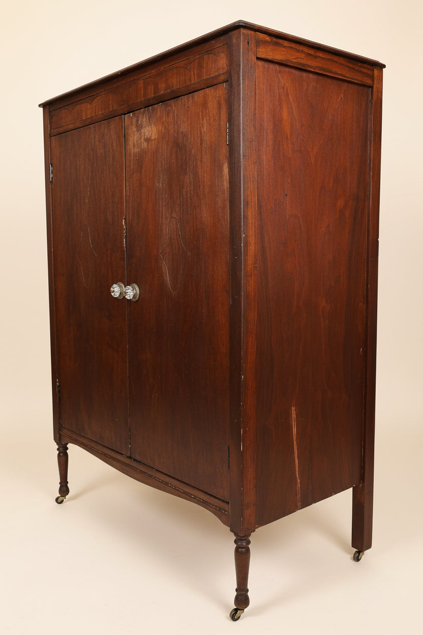 Wooden sideboard in a room with a sofa and framed picture on the wall.