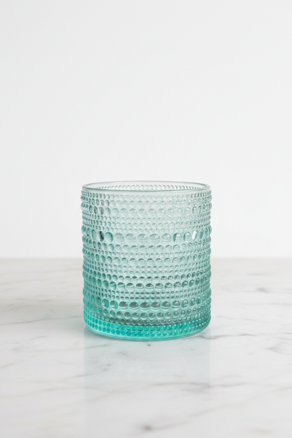 Single aqua blue hobnail rock glass on white marble, showing full cylindrical profile and raised bead texture, Home Essentials Halo