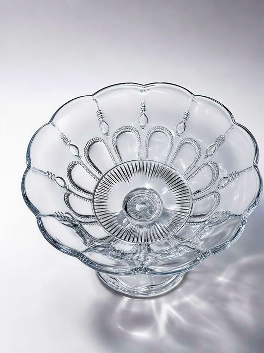 Top-down view of an antique Bryce Higbee "Beautiful Lady" clear pattern glass pedestal compote bowl, showing the intricate beaded gothic arches, rayed center, and scalloped rim details.