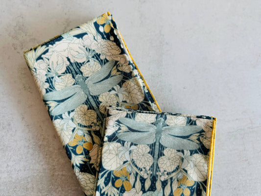 Floral patterned fabric pouches in teal and yellow, featuring dragonfly design, perfect for organization.