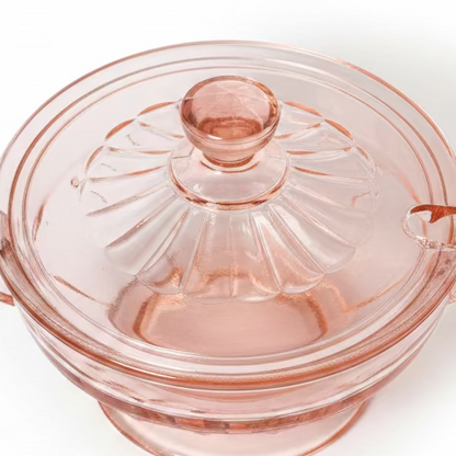 closeup Top-down perspective looking at the lidded pink depression glass sugar bowl, focusing on the decorative faceted finial and the fluted pattern on the lid, set against a white background.