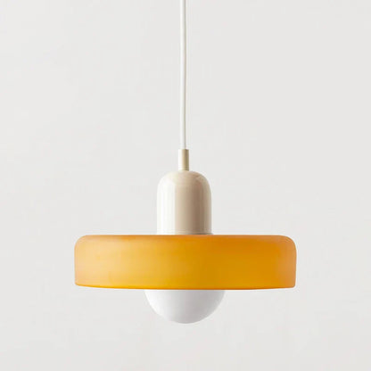 Pendant light with a yellow shade and white base on a light gray background