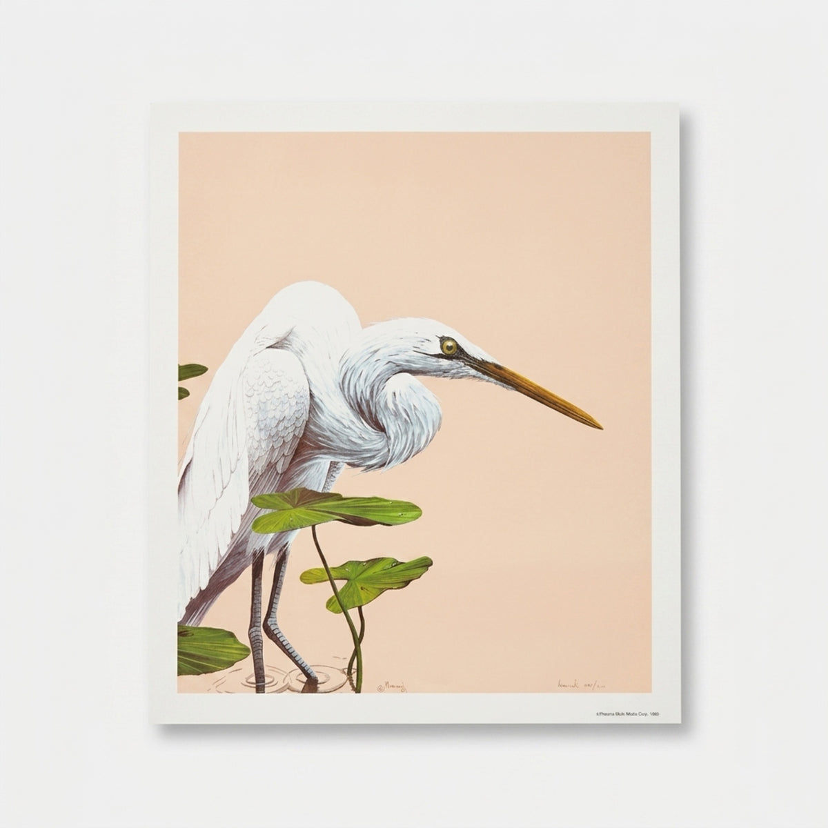 A full-view product shot of an unframed vintage 1980 limited edition wildlife lithograph print by the artist Moriarty, displayed loose on a natural wood surface. The artwork depicts a majestic white Great Egret bird standing gracefully in rippling water among green lily pads. The background is a solid, clean, minimalist warm neutral taupe and sand color. The print is in mint condition with sharp corners and bright white paper borders.