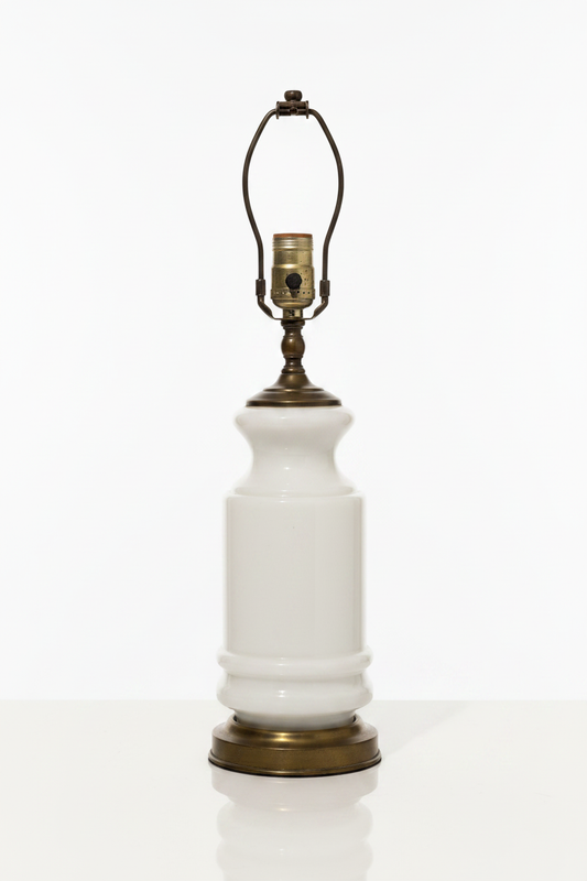 Vintage mid-century white milk glass table lamp base with antiqued brass harp and rotary socket — full view on white background