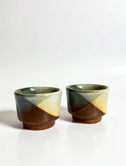 Detailed view of the Brutalist-style reactive glaze on California studio pottery, showing the sharp diagonal lines and textured matte finish of a vintage Pottery Craft ceramic vessel.
