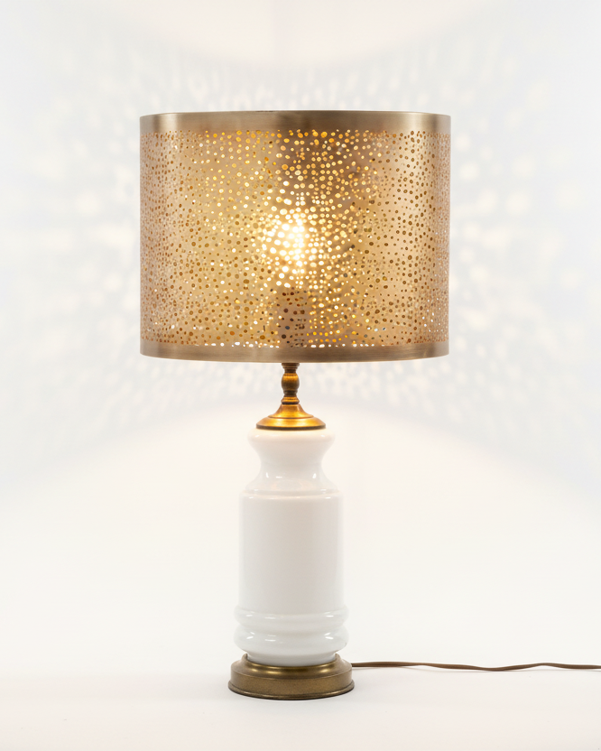 Vintage white milk glass table lamp base with perforated antiqued brass drum shade — mid-century style, studio product shot
